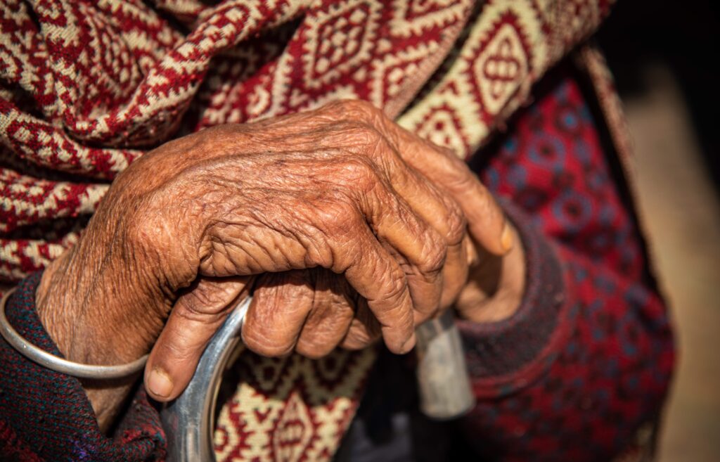 Close up of the crossed wrinkle hands of an elder